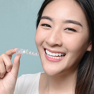 Adult woman placing clear aligner tray