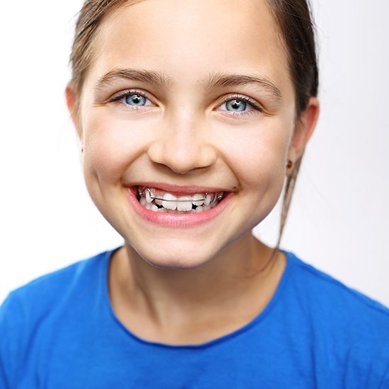 Smiling girl with orthodontic appliance