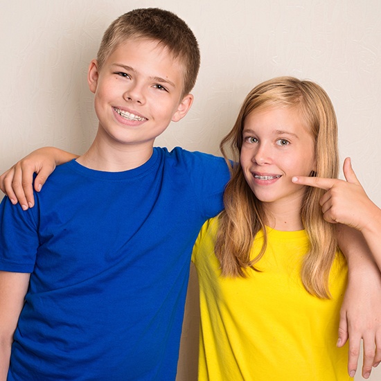 Teen boy and girl receiving dentofacial orthopedics