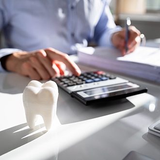 Man calculating cost of Invisalign in Grafton