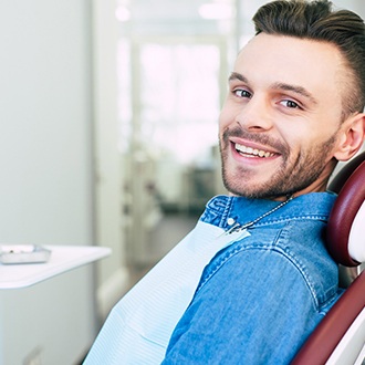 Man smiling after Invisalign treatment in Grafton