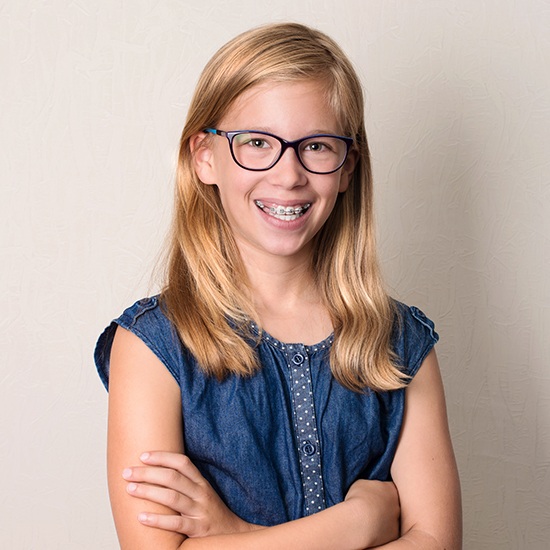 Smiling preteen girl with pediatric orthodontics