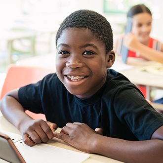 Smiling preteen boy with pediatric orthodontics