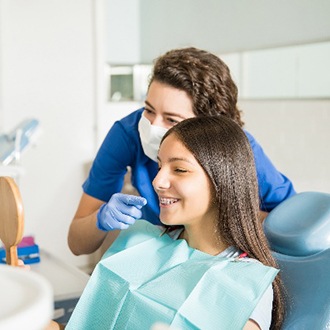 Orthodontist and patient with braces smiling in mirror