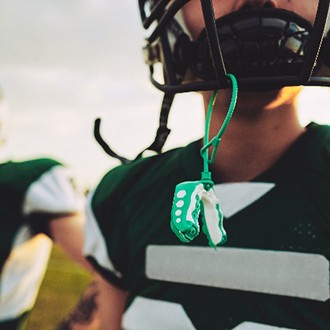 Closeup of mouthguard hanging from football helmet