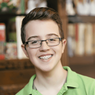 Teen boy with braces smiling