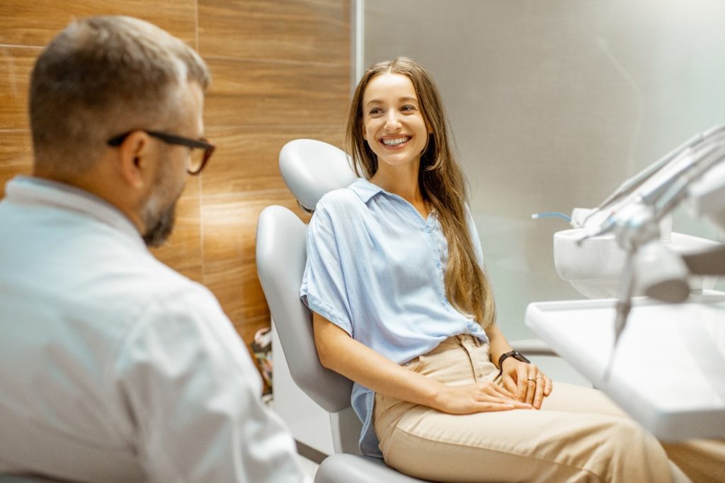 Female patient smiling at orthodontist at final appointment